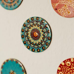 Vibrant hand-painted mandala wall decorations featuring intricate patterns and geometric designs.